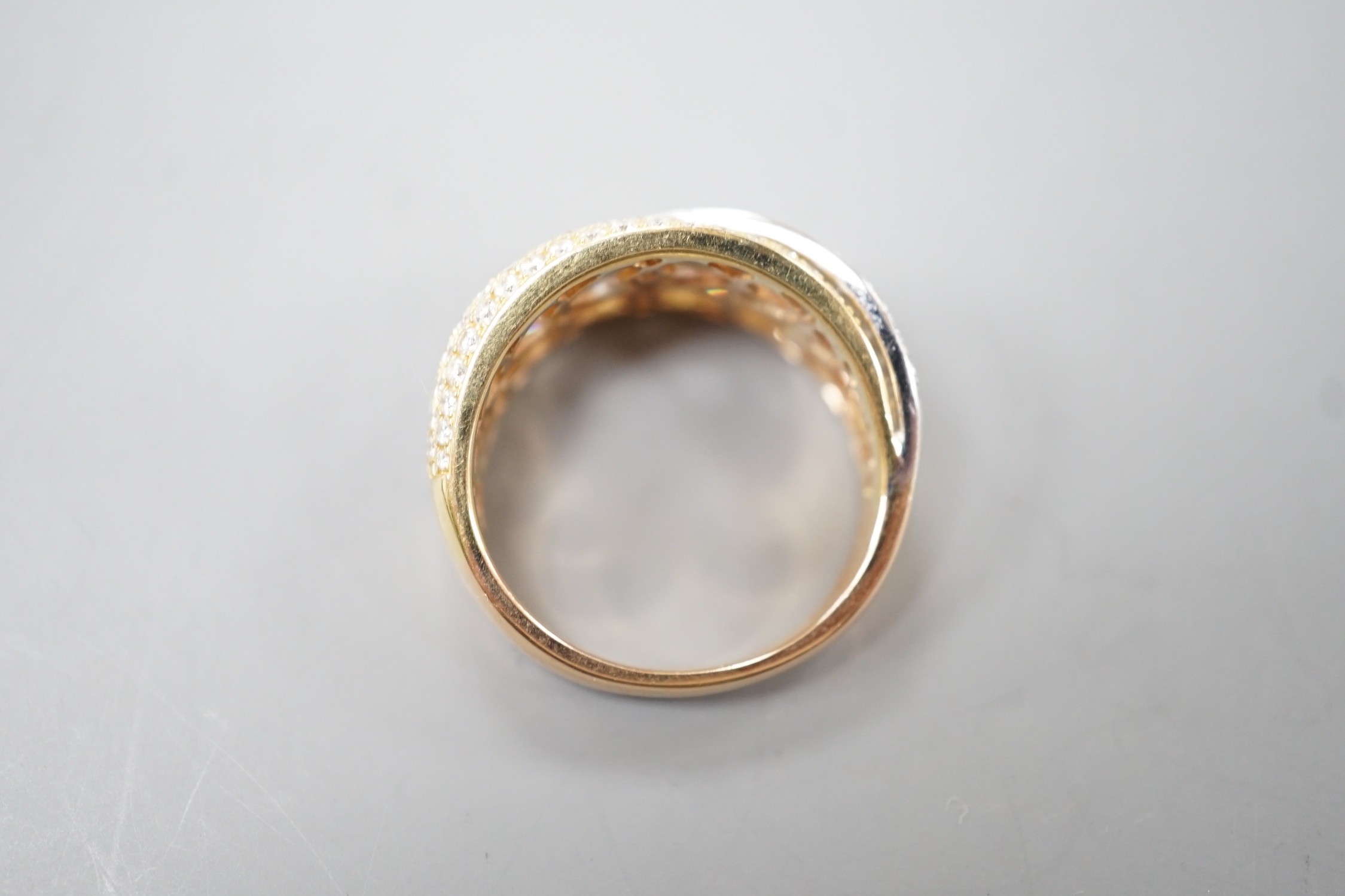 A modern three colour 18ct gold and diamond chip set triple band crossover ring, size O, gross weight 7 grams.